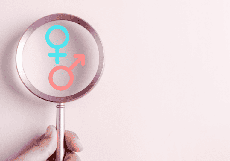 magnifying glass looking at boy or girl symbols