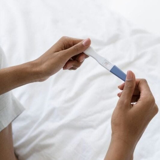 Holding a pregnancy test