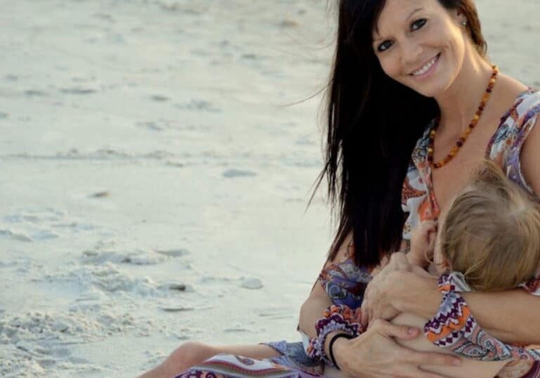 Breastfeeding mom on beach