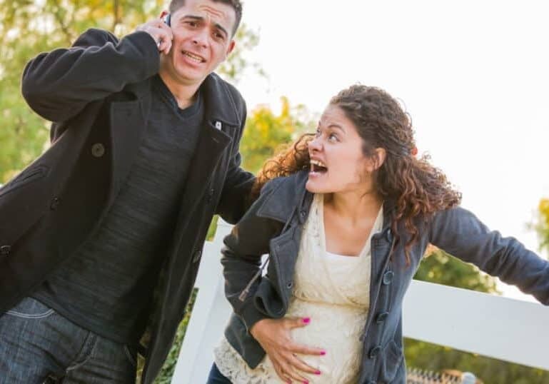 pregnant couple panicking because water just broke in park