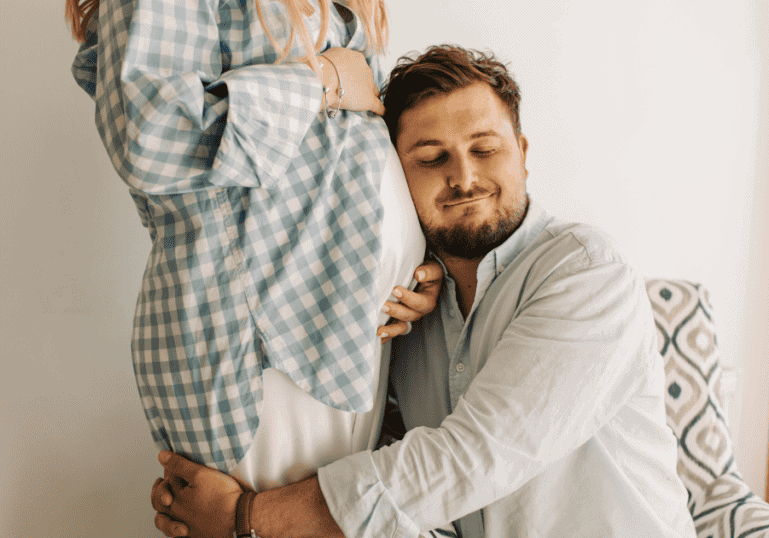 dad hugging pregnant partner