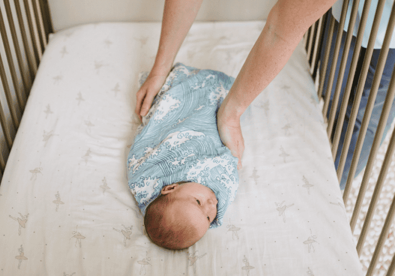 Safe Sleep For Baby with baby swaddled in crib