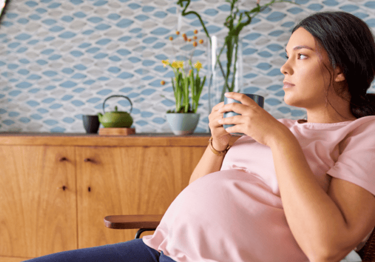 pregnant mom thinking in chair