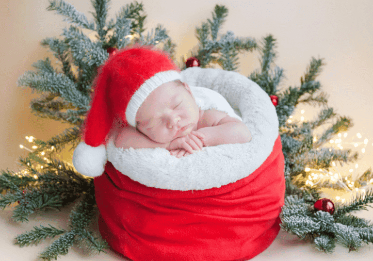 Newborn baby in a Santa hat