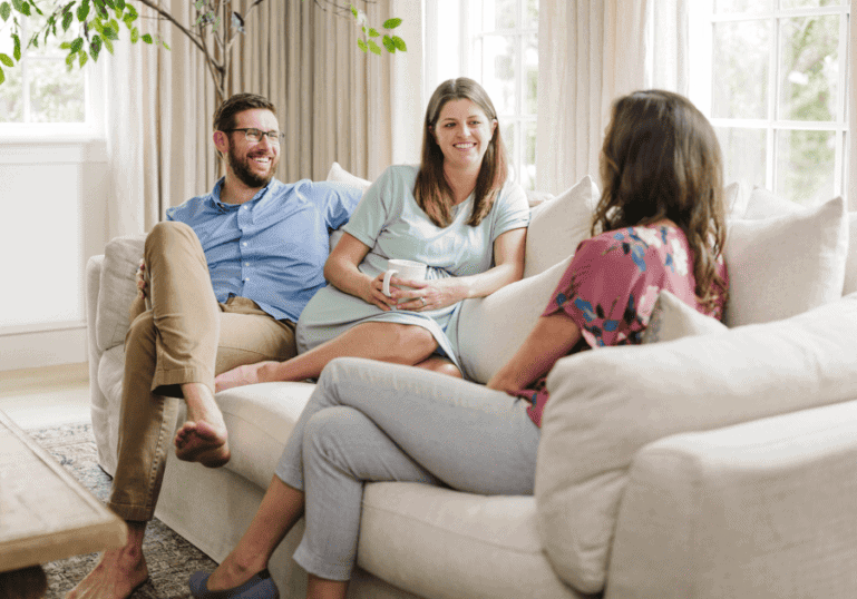 Tampa Birth Doula Meeting with a Pregnant Couple sitting on a couch