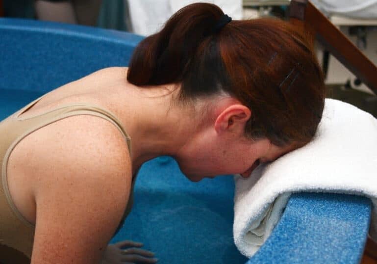 woman in labor in birth tub