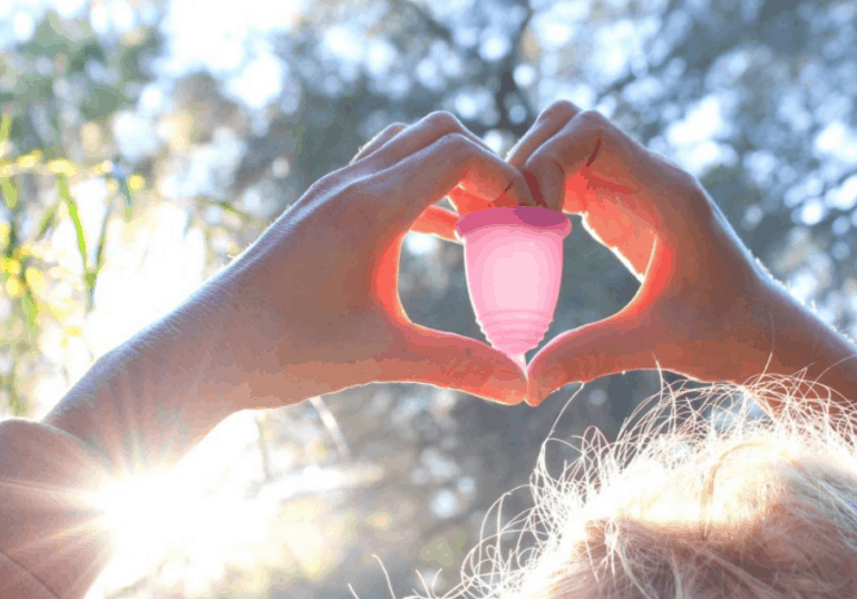 woman holding diva cup in the sun