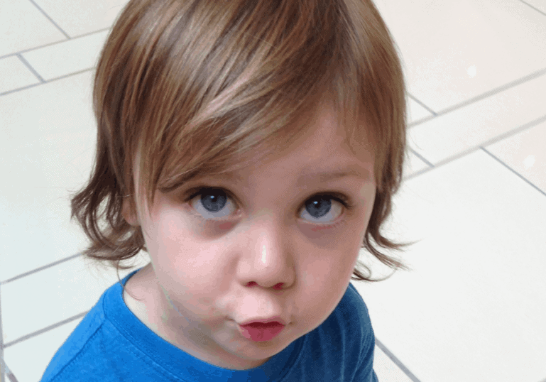 toddler looking up at mother with blue eyes