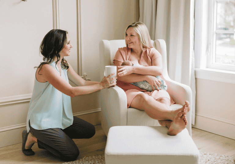 Tampa doula Christie Rinder offering a cup of tea to a new mom