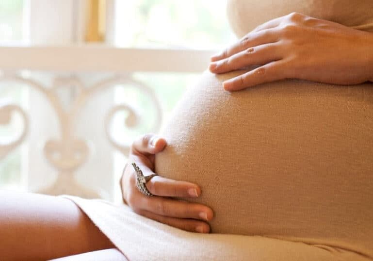 woman holding pregnant belly