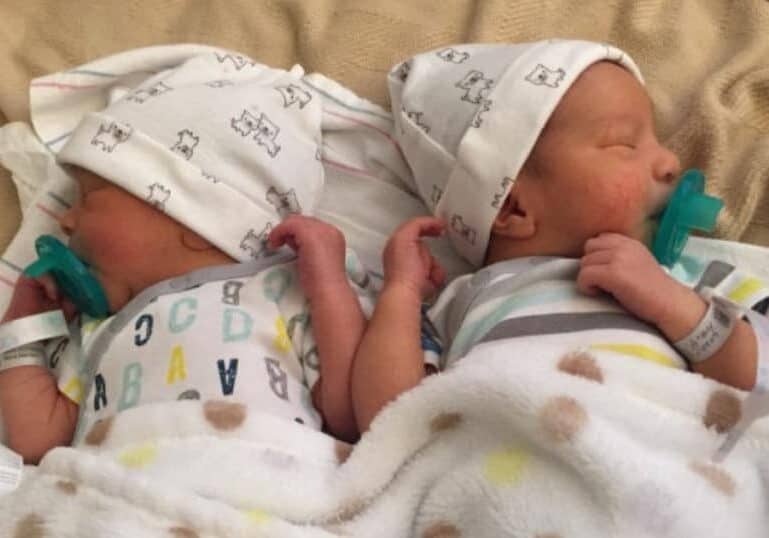 twin newborns with pacifiers