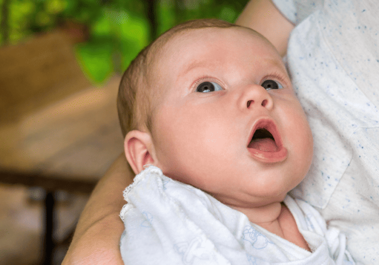 Baby with mouth open showing she is hungry