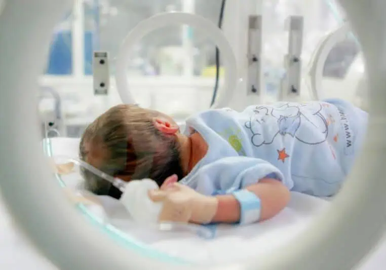 baby in NICU incubator