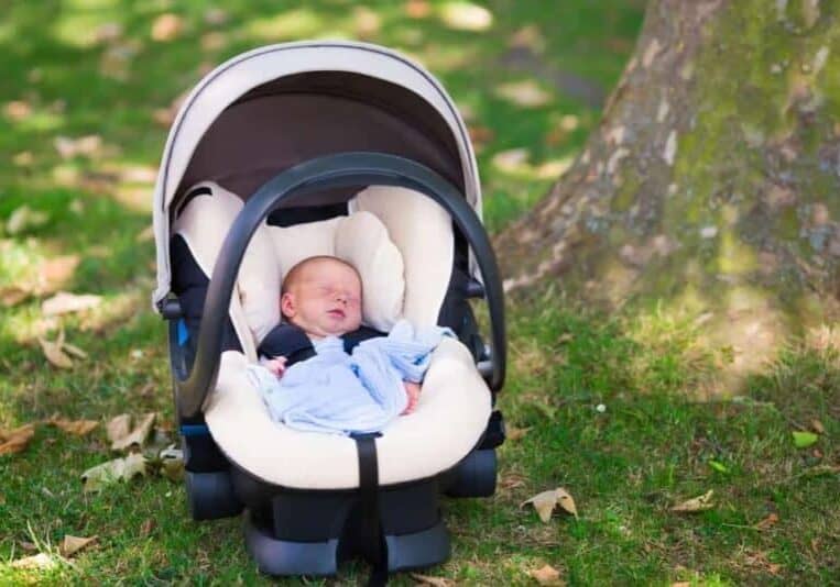 infant sleeping in car seat outside