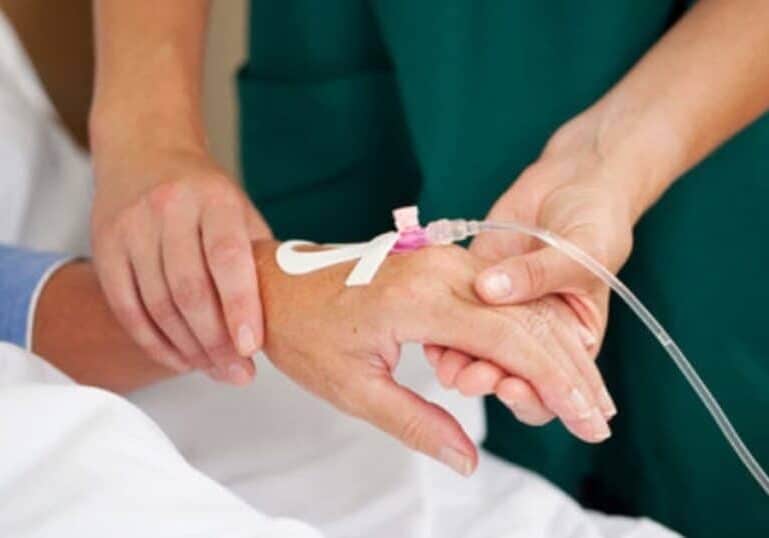 hospital labor induction with iv in patient's hand held by nurse