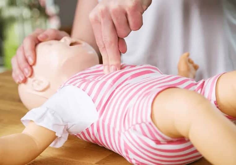 hands on practice in a Tampa Bay infant cpr class using infant doll