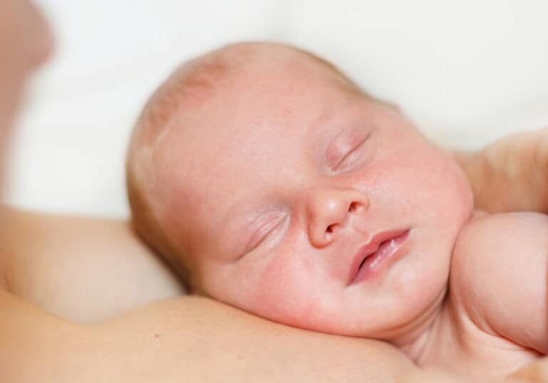 newborn baby skin to skin with parent