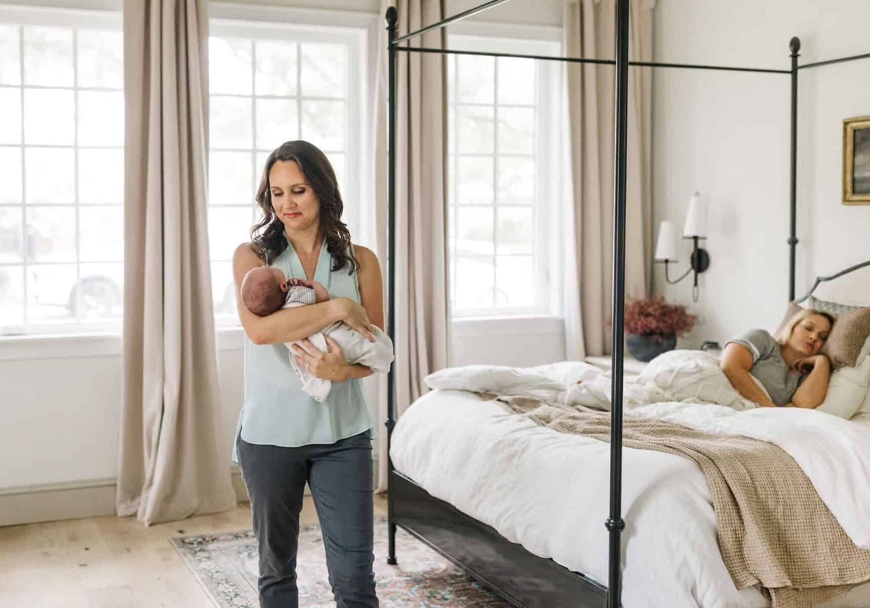 tampa bay postpartum doula holding baby in family bedroom