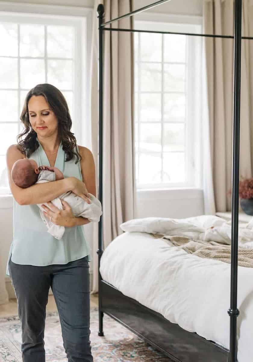 tampa bay postpartum doula holding baby in family bedroom